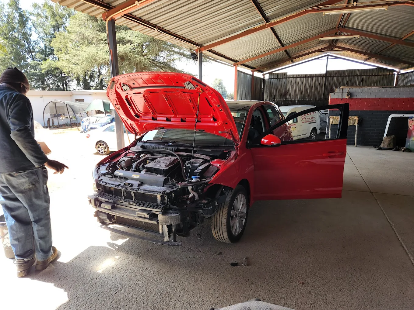 Accident repair on red vehicle — panel beating in progress at our Centurion workshop